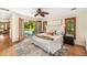 Serene main bedroom featuring French doors opening to the pool area, hardwood floors, and stylish decor at 600 Brechin Dr, Winter Park, FL 32792