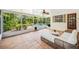 Screened patio with tile floor and comfortable seating overlooking the pool and landscaped yard at 600 Brechin Dr, Winter Park, FL 32792