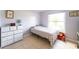 Cozy bedroom with natural light, light purple walls and neutral tile floors at 62 York Ct, Kissimmee, FL 34758