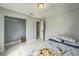 Bedroom with white walls and tile floors with a partially open closet at 62 York Ct, Kissimmee, FL 34758