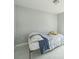 Bright bedroom with white walls, tile flooring and a single bed at 62 York Ct, Kissimmee, FL 34758