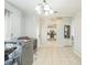 Bright kitchen with tiled floors, modern appliances and chandelier lighting at 62 York Ct, Kissimmee, FL 34758