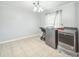 Spacious laundry room featuring new washer and dryer units, tile flooring, and plenty of room at 62 York Ct, Kissimmee, FL 34758