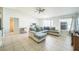 Bright and airy living room with tiled floors, a fan, and a comfortable sectional couch at 62 York Ct, Kissimmee, FL 34758