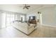 Open living room with tiled floors, a ceiling fan, and sliding glass doors to let in natural light at 62 York Ct, Kissimmee, FL 34758