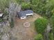 An aerial shot showcases a home nestled among mature trees with a private, spacious yard at 633 Hermits Trail, Altamonte Springs, FL 32701