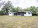 The back of the home features a screened in porch and a large backyard at 633 Hermits Trail, Altamonte Springs, FL 32701