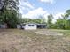 Spacious backyard view showing the home's rear exterior and surrounding trees at 633 Hermits Trail, Altamonte Springs, FL 32701
