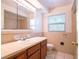 Bathroom featuring a large vanity, framed mirror, shower over tub, and tile flooring at 633 Hermits Trail, Altamonte Springs, FL 32701