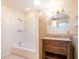 Bathroom showcasing a shower over tub combination with decorative tile and a wooden vanity with ample storage space at 633 Hermits Trail, Altamonte Springs, FL 32701