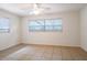 Cozy bedroom featuring tile floors, natural light from windows, and a ceiling fan for added comfort at 633 Hermits Trail, Altamonte Springs, FL 32701