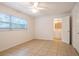 Inviting bedroom with tile flooring, a ceiling fan, and access to an ensuite bathroom, offering convenience at 633 Hermits Trail, Altamonte Springs, FL 32701