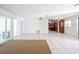 Bright living room with white tile floors that flow into an open-concept kitchen and access to a lanai through sliding glass doors at 633 Hermits Trail, Altamonte Springs, FL 32701