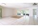 Open living room featuring white tile floor and sliding glass doors to porch at 633 Hermits Trail, Altamonte Springs, FL 32701