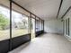 Large screened-in porch with tile floors, providing a relaxing outdoor living space at 633 Hermits Trail, Altamonte Springs, FL 32701