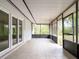 Enclosed back porch with tile flooring and screen panels providing an inviting space for outdoor relaxation at 633 Hermits Trail, Altamonte Springs, FL 32701