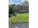 Relaxing backyard featuring a stone fire pit, Adirondack chairs, and green grass perfect for outdoor gatherings at 651 Holbrook Cir, Lake Mary, FL 32746