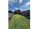 Expansive backyard with well-maintained lawn, fire pit seating, and a swing set for Gathering fun at 651 Holbrook Cir, Lake Mary, FL 32746