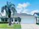 Charming home with a two-car garage, neat landscaping, and a mature palm tree in a well-maintained lawn at 651 Holbrook Cir, Lake Mary, FL 32746