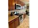 Modern kitchen featuring stainless steel appliances, granite countertops, and sleek dark wood cabinetry at 651 Holbrook Cir, Lake Mary, FL 32746