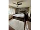 Comfortable main bedroom with wood accent wall, ceiling fan, and dark wood furniture at 651 Holbrook Cir, Lake Mary, FL 32746