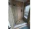 Modern tiled shower with glass enclosure and brushed nickel fixtures, including window with blinds at 651 Holbrook Cir, Lake Mary, FL 32746