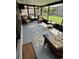 Relaxing screened-in sunroom with comfortable seating and view of the backyard at 651 Holbrook Cir, Lake Mary, FL 32746