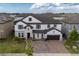 A beautiful aerial view of a two-story house, highlighting its landscaped front yard and brick driveway at 8109 Ludington Cir, Orlando, FL 32836