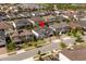 Aerial view of a home with a red pin on the roof, surrounded by other homes in a planned community near a lake at 8109 Ludington Cir, Orlando, FL 32836