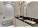 Bathroom featuring double sinks, granite countertops, a bath tub with a shower, and modern fixtures at 8109 Ludington Cir, Orlando, FL 32836