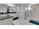 Bright bathroom featuring double sinks, granite countertops, a soaking tub, and a separate glass-enclosed shower at 8109 Ludington Cir, Orlando, FL 32836