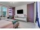 Stylish bedroom with modern decor, desk, and floating shelves, creating a comfortable and functional space at 8109 Ludington Cir, Orlando, FL 32836
