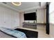 Stylish bedroom with a modern entertainment center, a large flat-screen TV, and unique accent lighting at 8109 Ludington Cir, Orlando, FL 32836