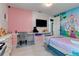 Colorful bedroom featuring fairytale princess decor, a cozy bed, and functional workspace at 8109 Ludington Cir, Orlando, FL 32836