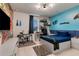 Modern bedroom featuring a blue accent wall, game-themed decor, and white wood flooring at 8109 Ludington Cir, Orlando, FL 32836