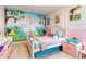 Whimsical bedroom featuring fairytale princess decor, a cozy bed, and cheerful wall art at 8109 Ludington Cir, Orlando, FL 32836