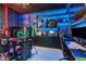 Impressive gaming room with dynamic lighting, custom shelving, and multiple gaming setups for the ultimate entertainment experience at 8109 Ludington Cir, Orlando, FL 32836