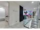 Hallway with glass railings leads to a living room and bathroom at 8109 Ludington Cir, Orlando, FL 32836