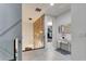 Hallway with white floors and walls, glass railings, and a decorative wood accent wall at 8109 Ludington Cir, Orlando, FL 32836