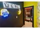 Fun hallway with Minions-themed decor, including neon signs and playful banana accents at 8109 Ludington Cir, Orlando, FL 32836