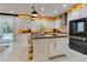 Bright kitchen with a large island, premium appliances, stylish pendant lighting, and sliding doors to the outside at 8109 Ludington Cir, Orlando, FL 32836