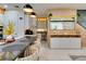 Modern kitchen with island seating, undermount lighting, and a mirror backsplash, perfect for culinary adventures at 8109 Ludington Cir, Orlando, FL 32836