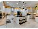 Well-equipped kitchen with custom cabinetry, stainless appliances, island seating, and ample countertop space at 8109 Ludington Cir, Orlando, FL 32836