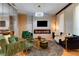 Modern living room with an electric fireplace and stylish furniture under a decorative chandelier at 8109 Ludington Cir, Orlando, FL 32836