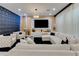 Spacious living room with unique 3D accent wall, modern lighting, and plush white seating at 8109 Ludington Cir, Orlando, FL 32836