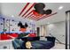 Spacious living room with Mickey Mouse themed decor and a large comfortable sectional sofa at 8109 Ludington Cir, Orlando, FL 32836