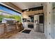 Well-equipped outdoor kitchen featuring stainless steel appliances and ample counter space, perfect for alfresco dining and entertaining at 8109 Ludington Cir, Orlando, FL 32836