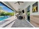 Spacious outdoor patio with a dining area, and a bar for relaxing and entertaining by the pool at 8109 Ludington Cir, Orlando, FL 32836