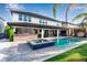 Stunning backyard oasis featuring a pool, spa, outdoor kitchen, covered patio, and lush landscaping at 8109 Ludington Cir, Orlando, FL 32836