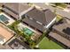 Aerial view of a two-story home showcasing the backyard pool, spa, patio, pergola, and well-manicured landscaping at 8109 Ludington Cir, Orlando, FL 32836